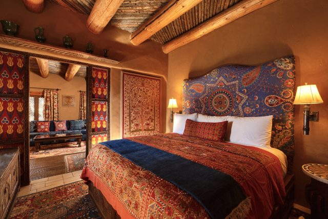 The bedroom in Adobe Rose; the newest suite at The Inn of The Five Graces, a Luxury Boutique Hotel and resort in Downtown Santa Fe, New Mexico.